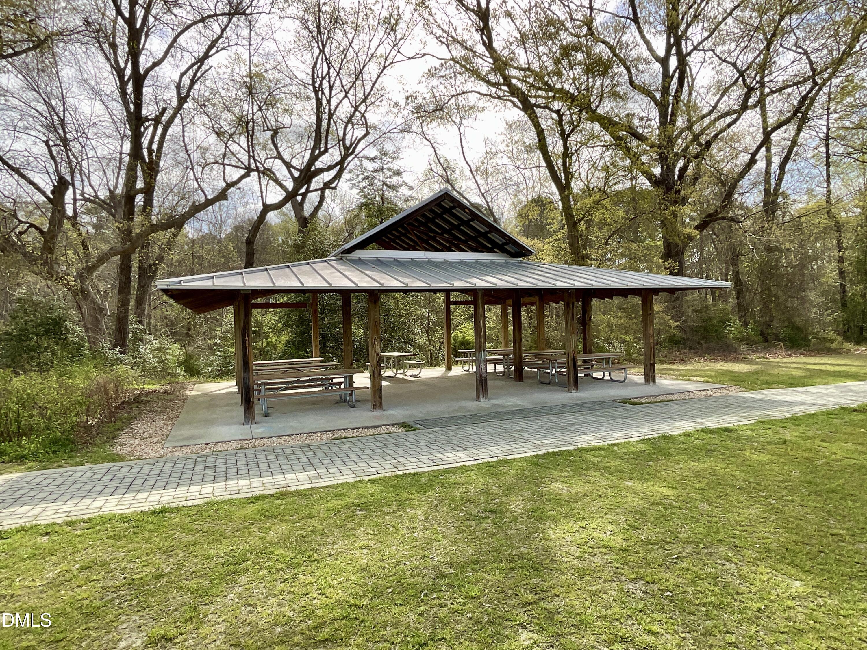 8712 Wardle Court Wake Forest, NC 27587 - Photo 33 of 33 a view of pool with a table and chairs under an umbrella