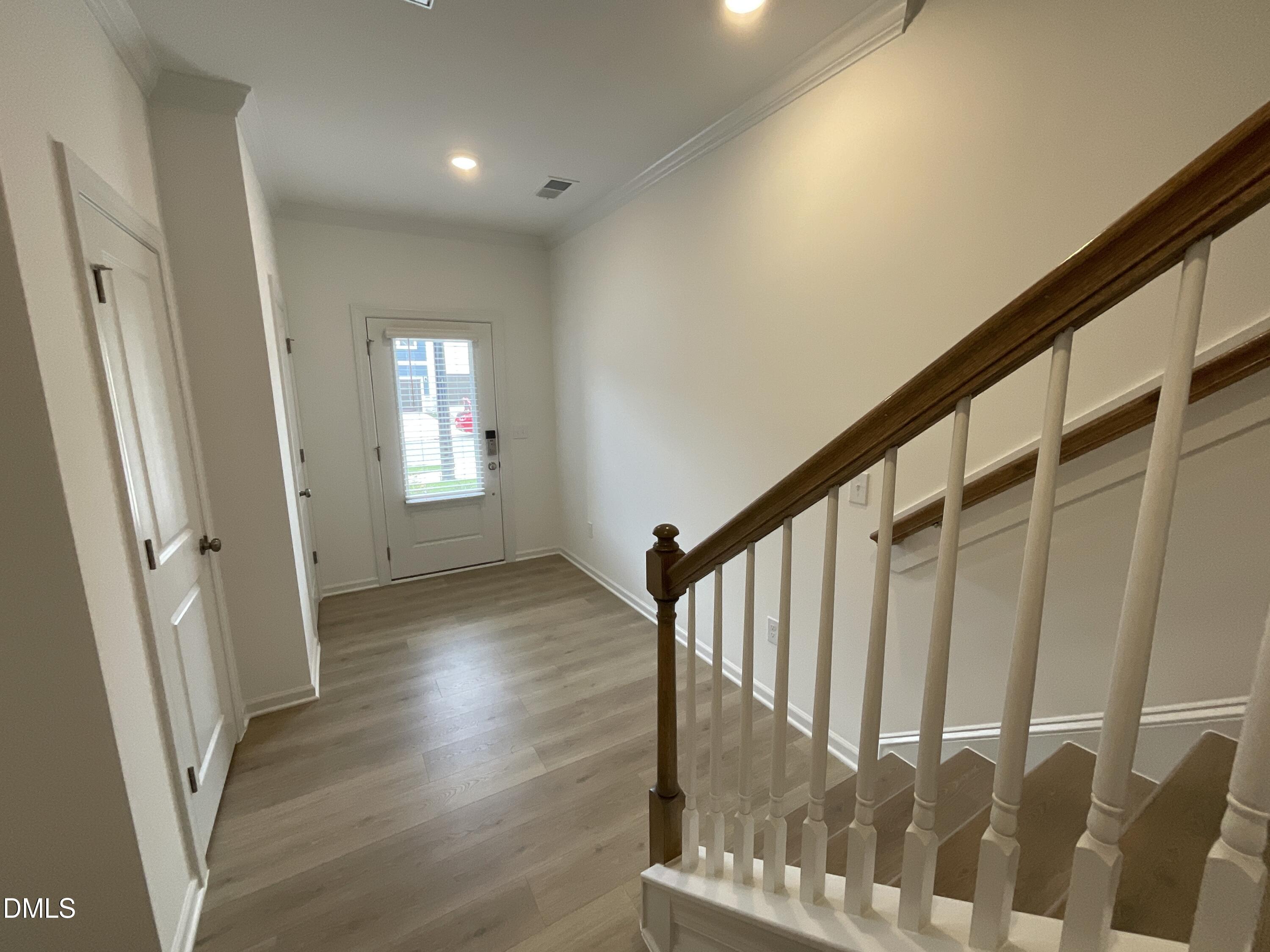 8712 Wardle Court Wake Forest, NC 27587 - Photo 4 of 33 a view of an entryway with wooden floor