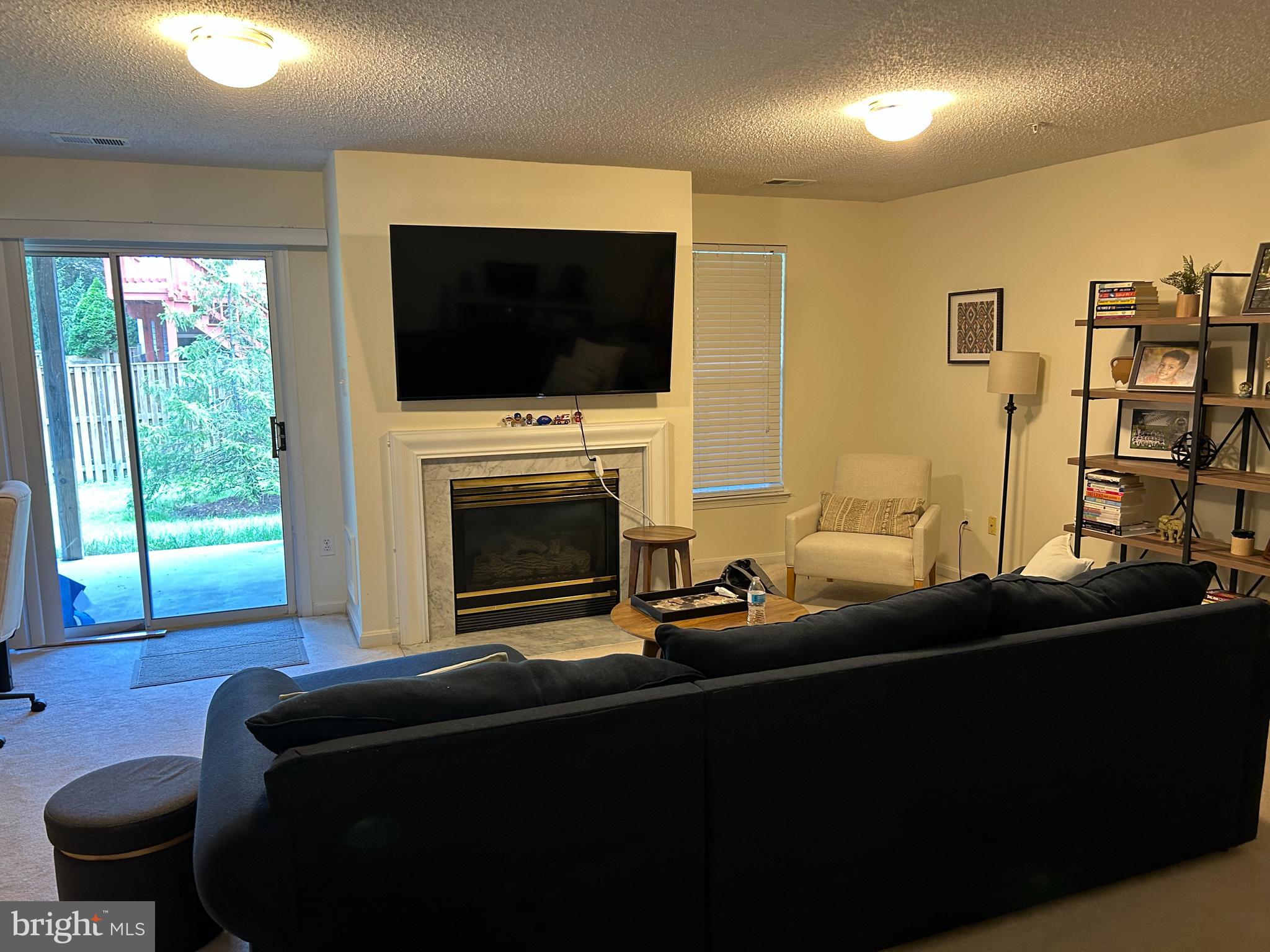 2304 Cold Meadow Way Silver Spring, MD 20906 - Photo 17 of 42 a living room with fireplace furniture and a flat screen tv