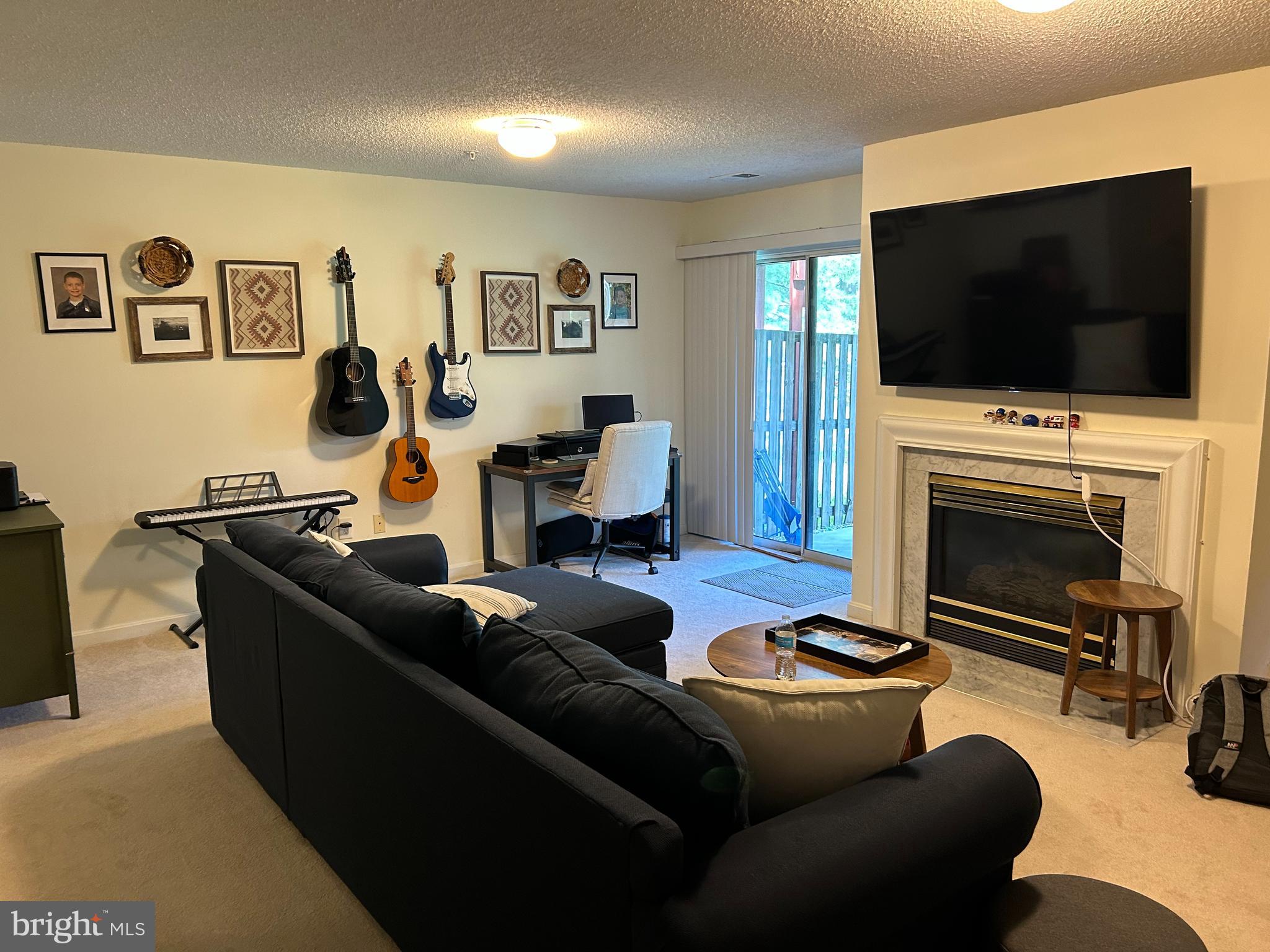 2304 Cold Meadow Way Silver Spring, MD 20906 - Photo 18 of 42 a living room with furniture a flat screen tv and a fireplace