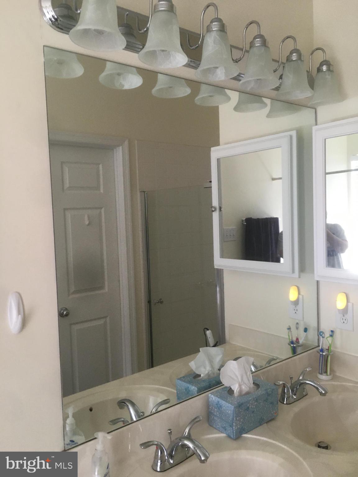 2304 Cold Meadow Way Silver Spring, MD 20906 - Photo 29 of 42 a bathroom with a granite countertop sink and a mirror