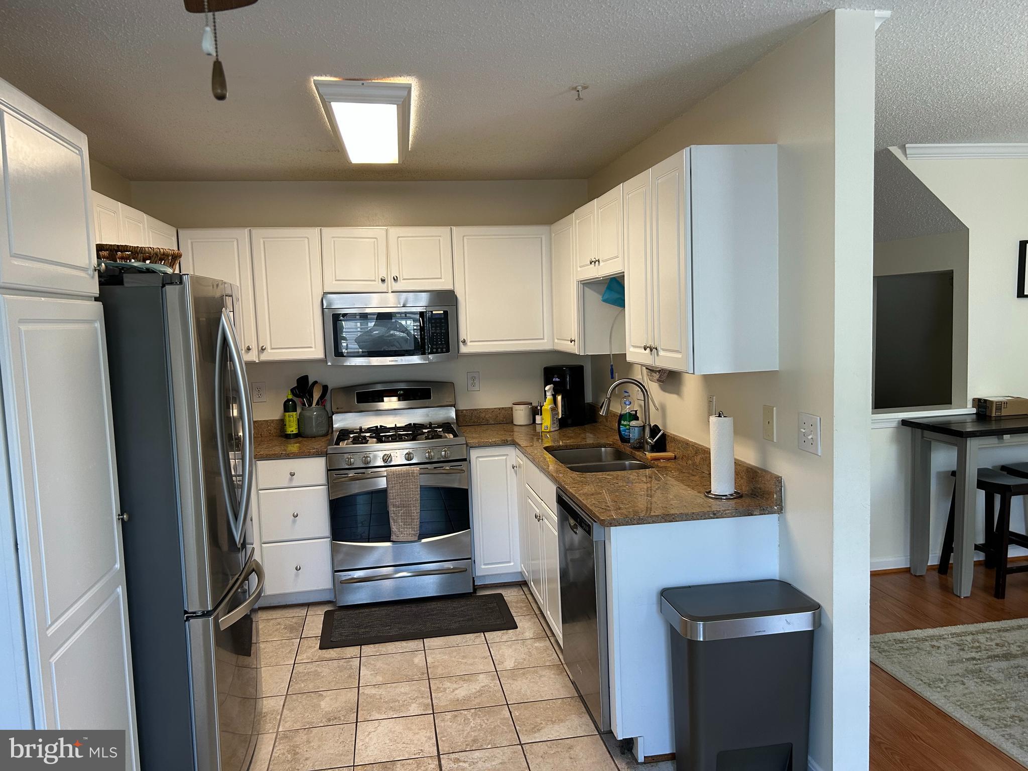 2304 Cold Meadow Way Silver Spring, MD 20906 - Photo 10 of 42 a kitchen with stainless steel appliances granite countertop a refrigerator stove and microwave