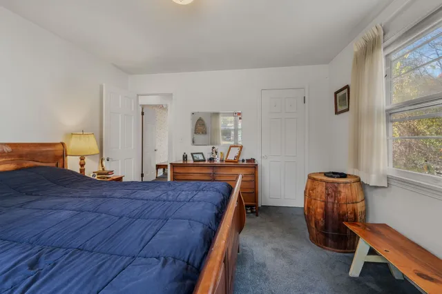 a bedroom with bed and window