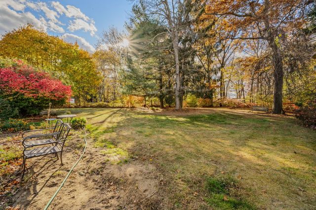 a view of yard with swimming pool and green space