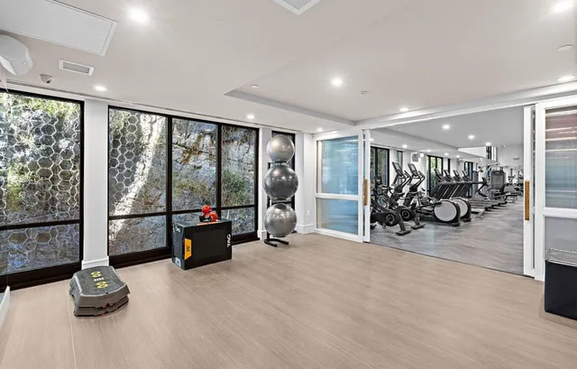 a view of a room with gym equipment and a large window