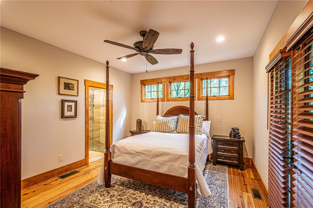1038 Wilkins Cove Road Suches, GA 30572 - Photo 24 of 89 a bedroom with a bed and wooden floor