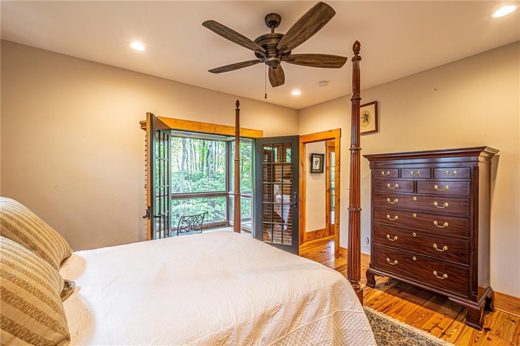 1038 Wilkins Cove Road Suches, GA 30572 - Photo 27 of 89 a bedroom with a bed window and a ceiling fan