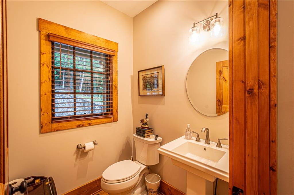 1038 Wilkins Cove Road Suches, GA 30572 - Photo 33 of 89 a bathroom with a sink a toilet and a mirror