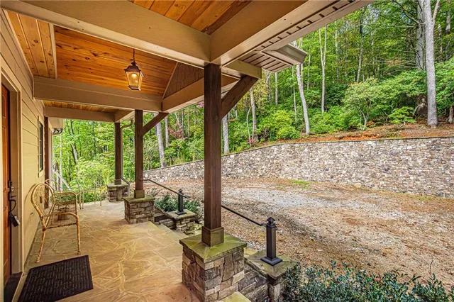 a view of a patio with a table chairs and wooden fence