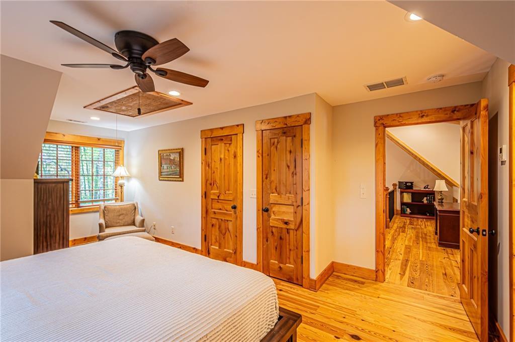 1038 Wilkins Cove Road Suches, GA 30572 - Photo 44 of 89 a bedroom with a bed and a chandelier