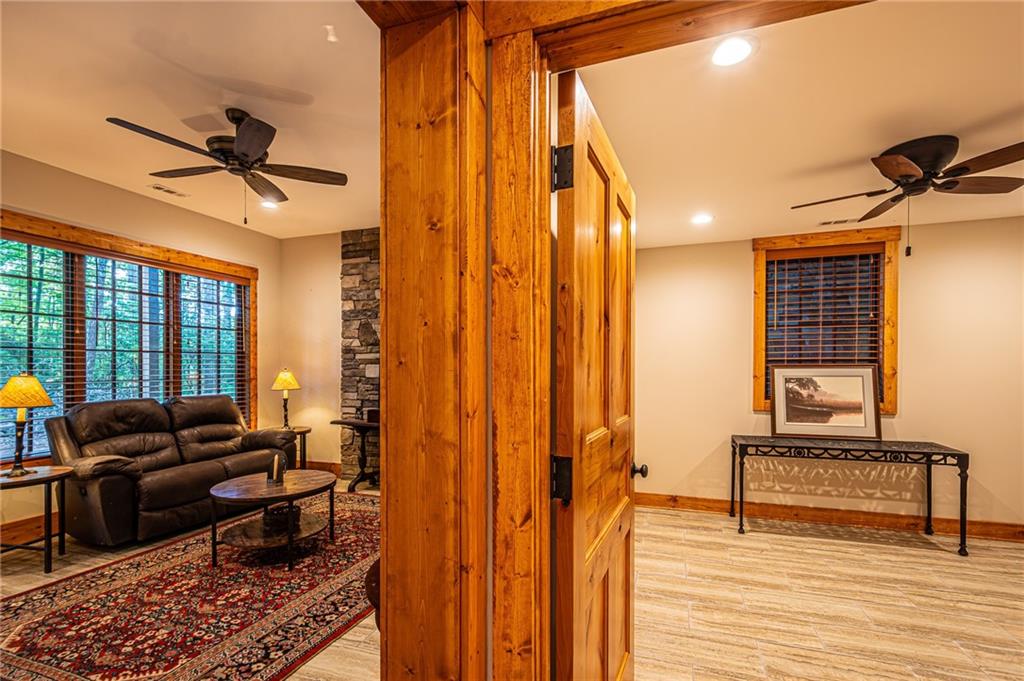 1038 Wilkins Cove Road Suches, GA 30572 - Photo 49 of 89 a living room with furniture a ceiling fan and a window