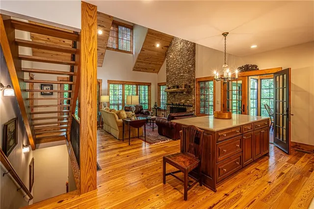 a living room with furniture floor to ceiling windows and a rug