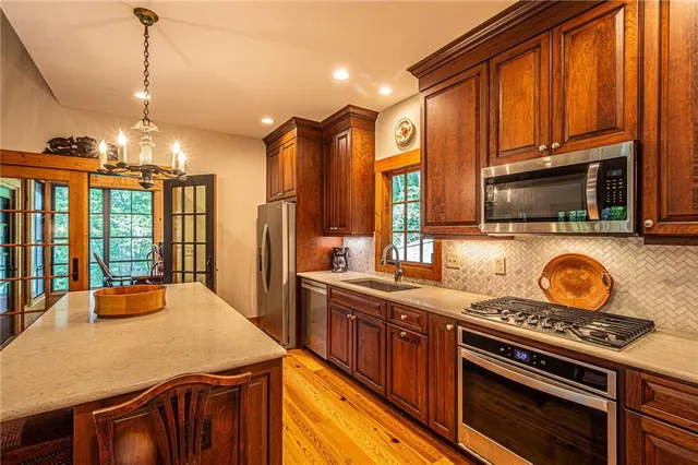 a living room with furniture a fireplace and a floor to ceiling window