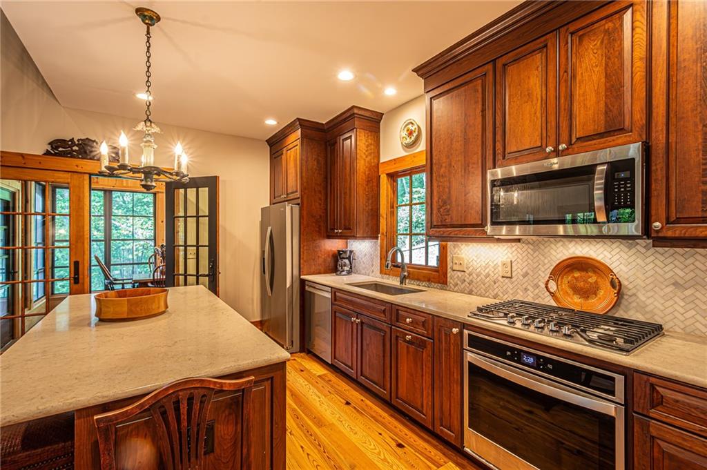1038 Wilkins Cove Road Suches, GA 30572 - Photo 10 of 89 a kitchen with a stove a sink and a refrigerator