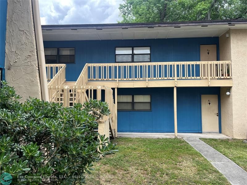 Brandywine Condominiums Gainesville, FL 32608 - Photo 17 of 18 a front view of a house with a yard