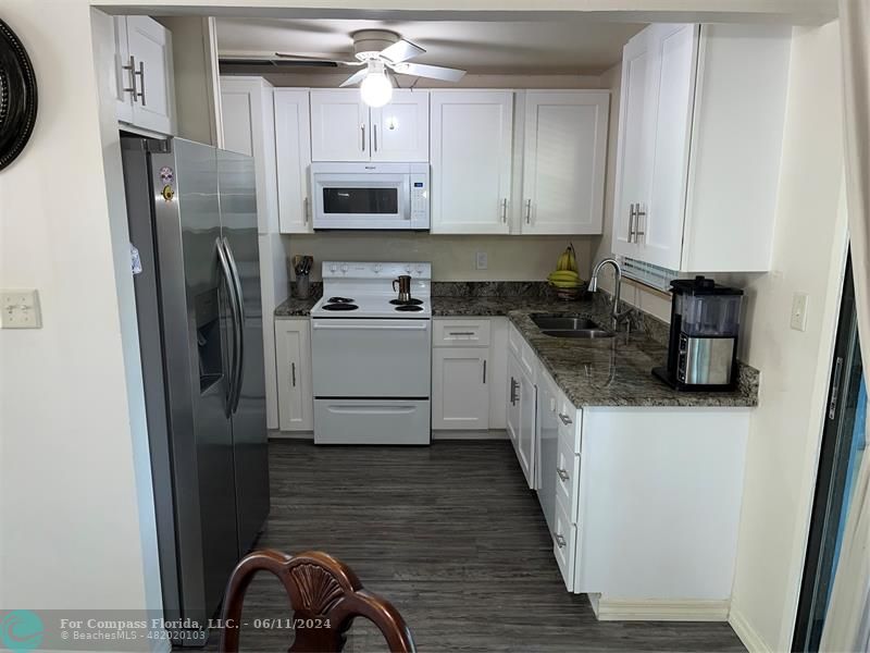 Brandywine Condominiums Gainesville, FL 32608 - Photo 6 of 18 a kitchen with stainless steel appliances a refrigerator a sink a stove a microwave and cabinets