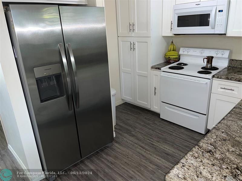 Brandywine Condominiums Gainesville, FL 32608 - Photo 7 of 18 a kitchen with metallic refrigerator sink and cabinets