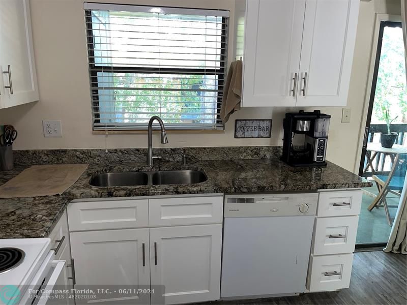 Brandywine Condominiums Gainesville, FL 32608 - Photo 8 of 18 a kitchen with granite countertop white cabinets and white appliances