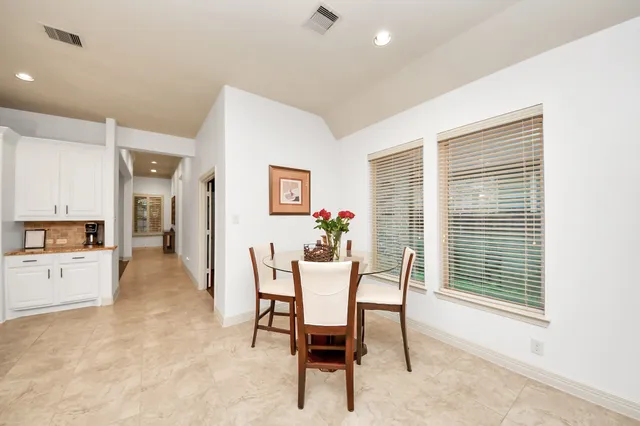 a dining room with furniture and window
