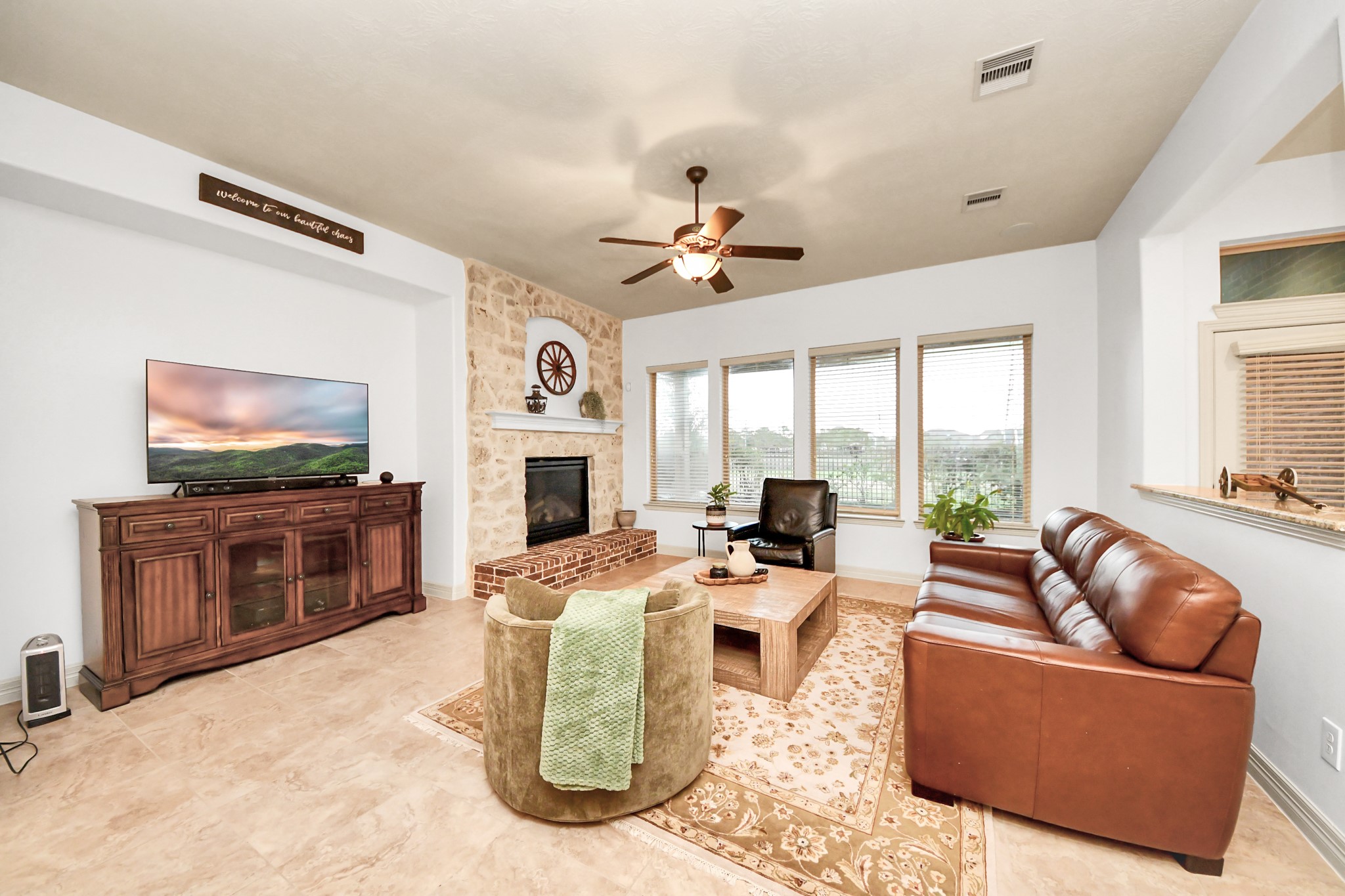 10410 Mossback Pine Road Katy, TX 77494 - Photo 12 of 34 a living room with fireplace furniture and a flat screen tv