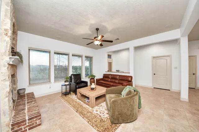 a living room with furniture and a floor to ceiling window