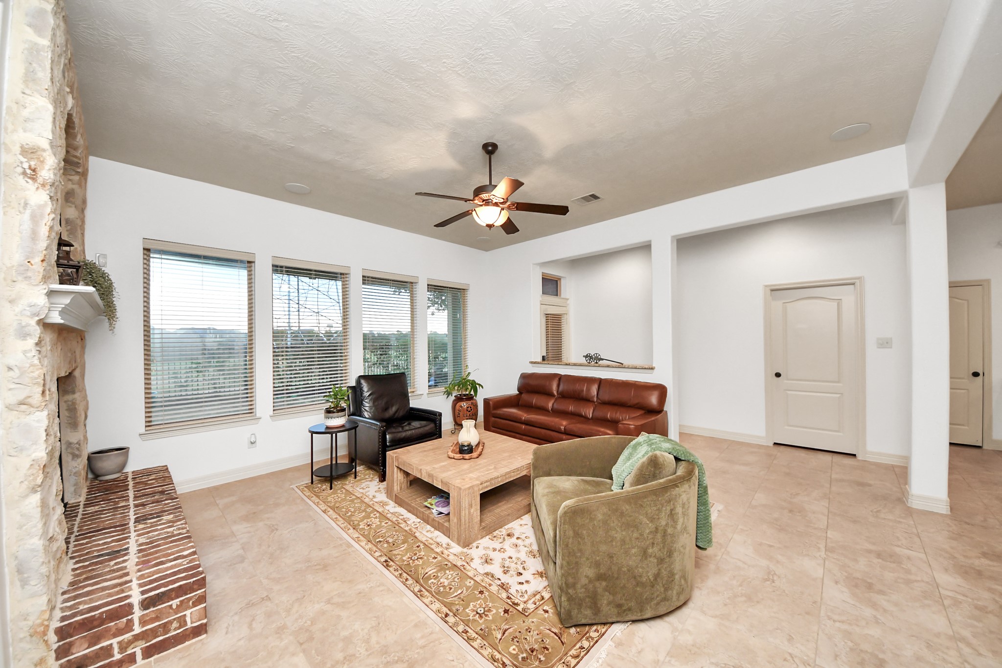 10410 Mossback Pine Road Katy, TX 77494 - Photo 13 of 34 a living room with furniture and a floor to ceiling window