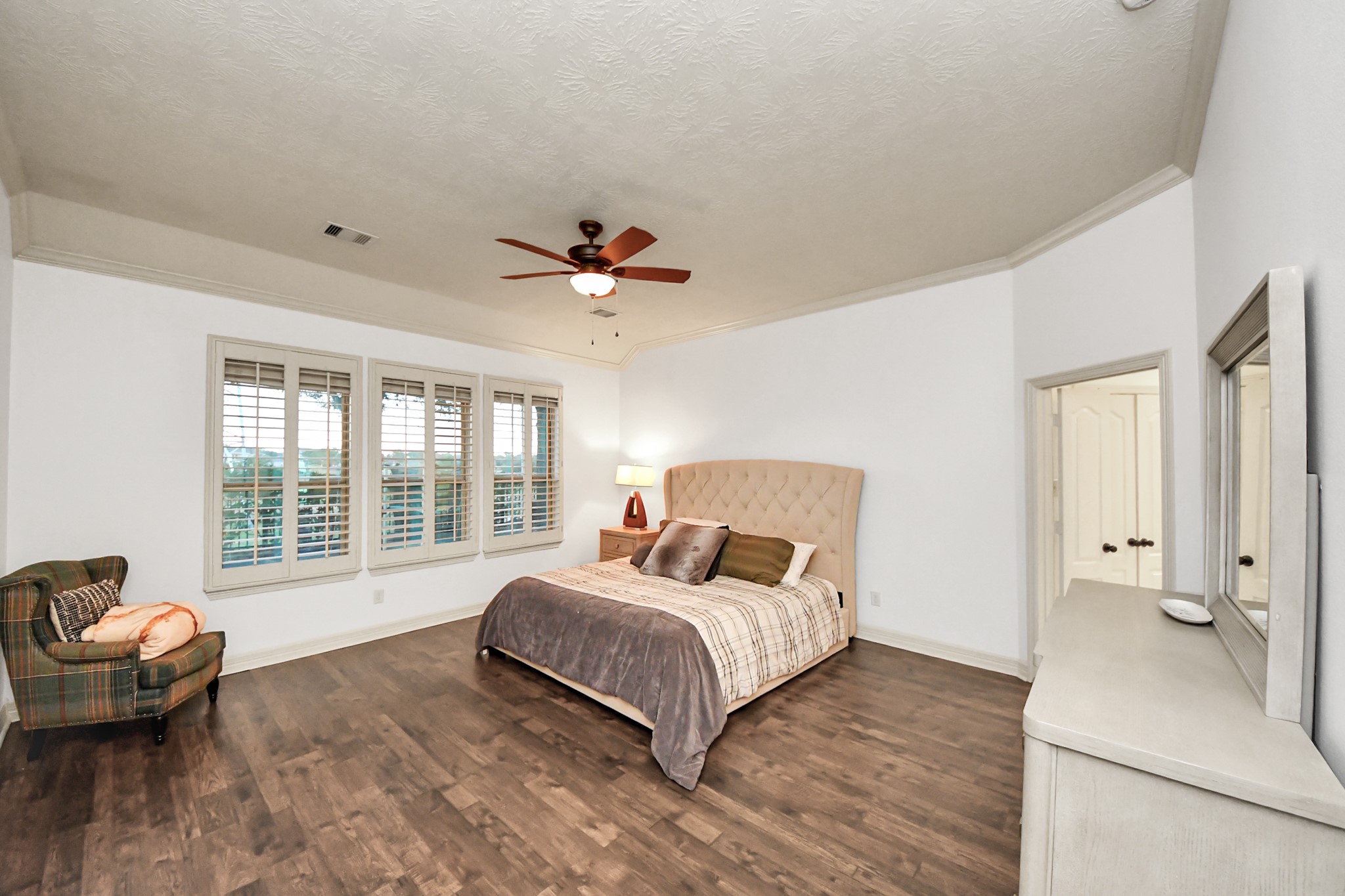 10410 Mossback Pine Road Katy, TX 77494 - Photo 14 of 34 a bedroom with a bed and wooden floor