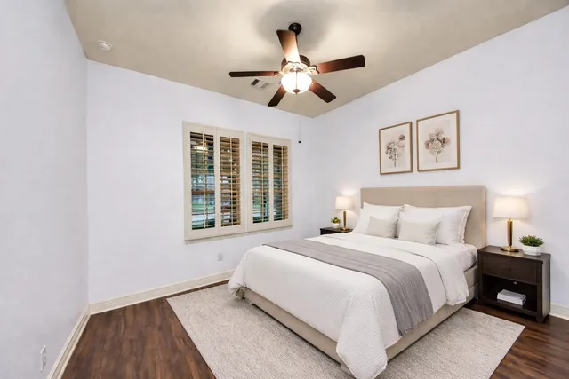 a bedroom with a large bed and a large window