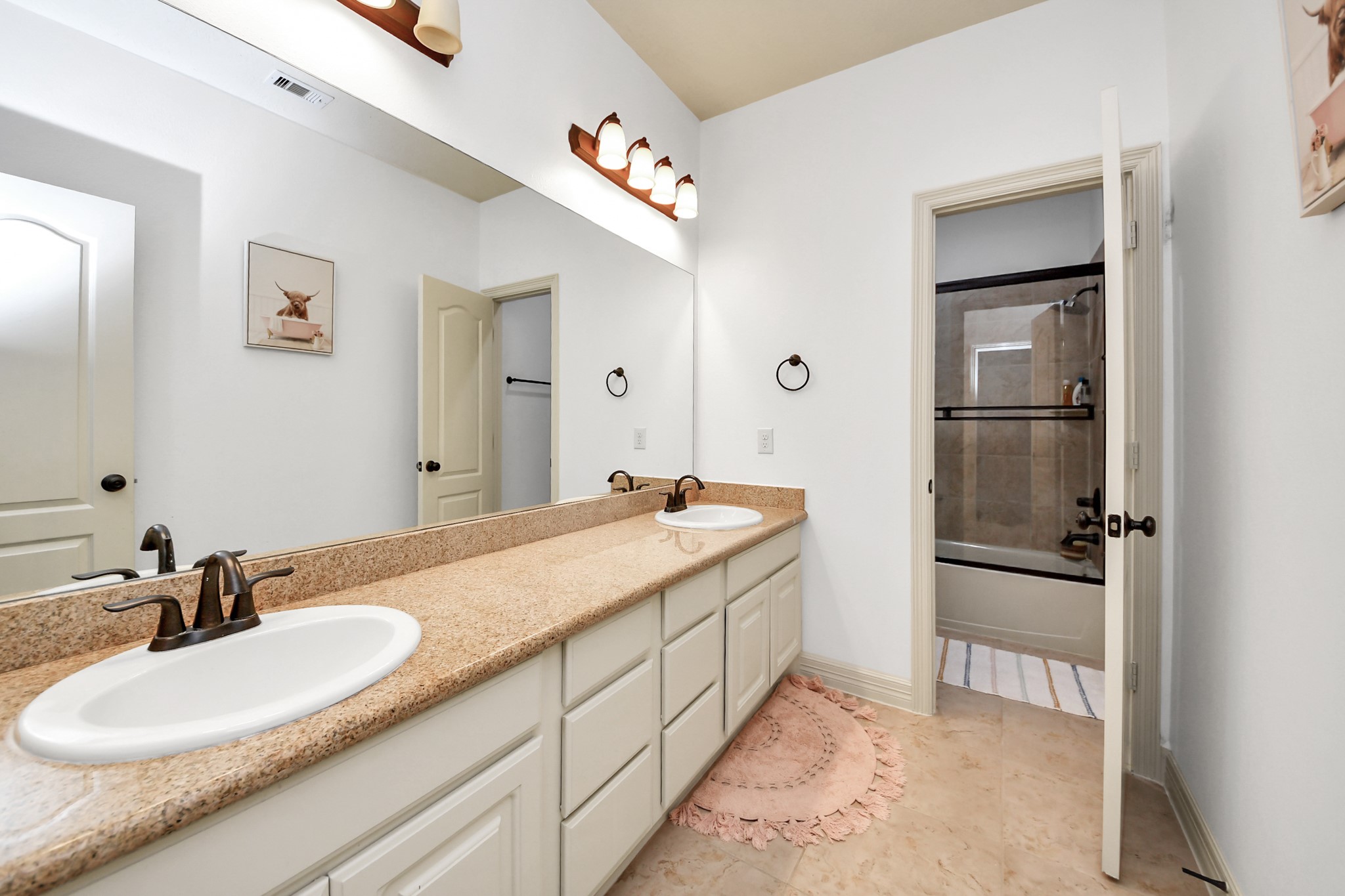 10410 Mossback Pine Road Katy, TX 77494 - Photo 24 of 34 a bathroom with a sink and a mirror