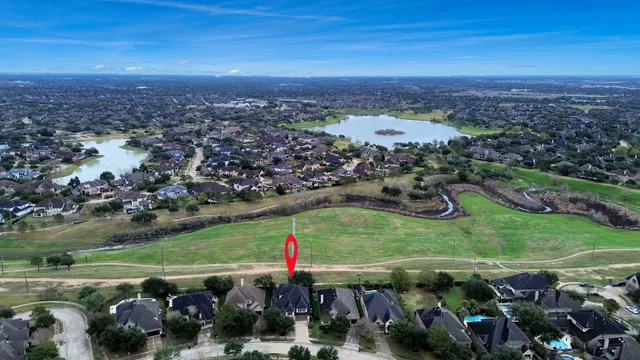 an aerial view of residential house with outdoor space and swimming pool