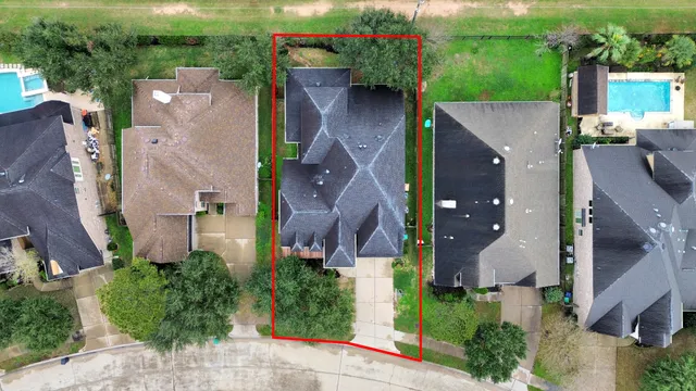 an aerial view of a house with a yard