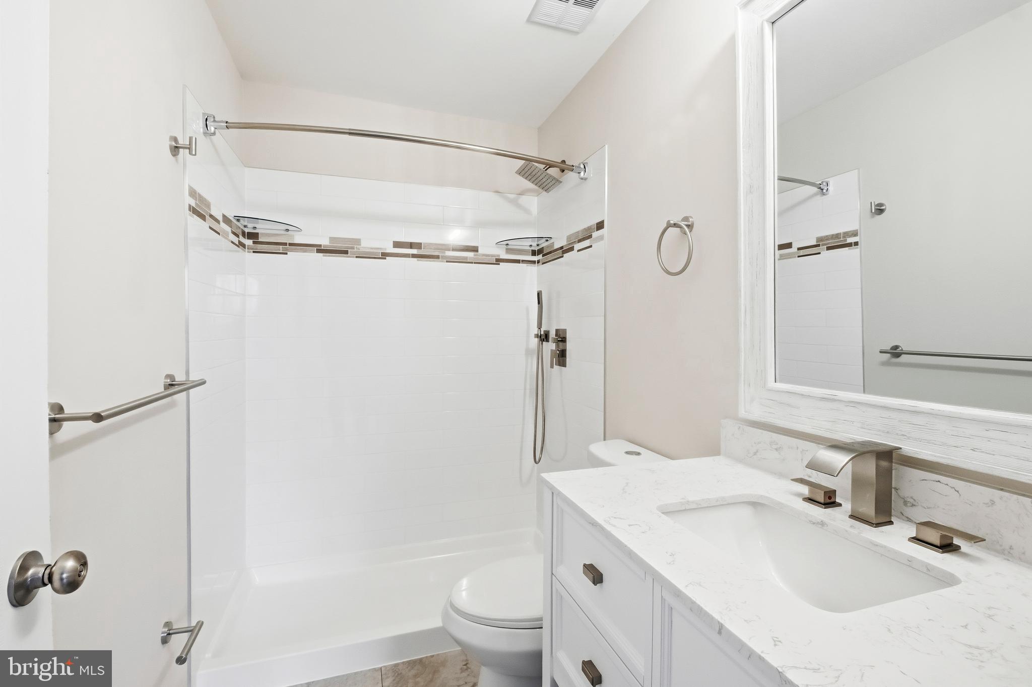 15012 Wheatland Place Laurel, MD 20707 - Photo 11 of 24 a bathroom with a granite countertop sink toilet and shower
