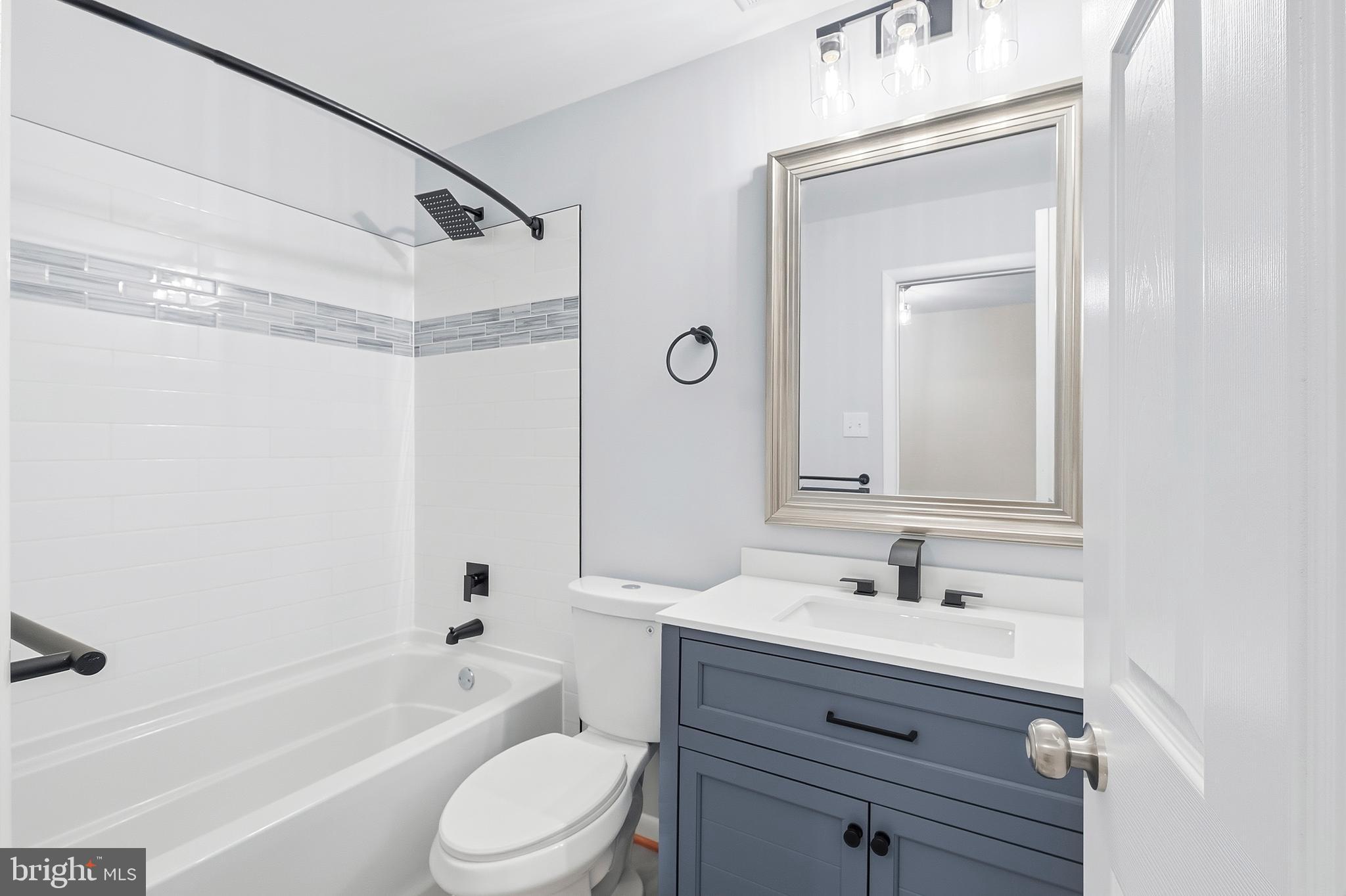 15012 Wheatland Place Laurel, MD 20707 - Photo 12 of 24 a bathroom with a sink a toilet and shower