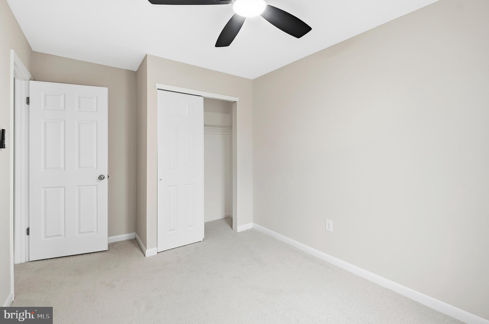 15012 Wheatland Place Laurel, MD 20707 - Photo 14 of 24 an empty room with a ceiling fan and a window