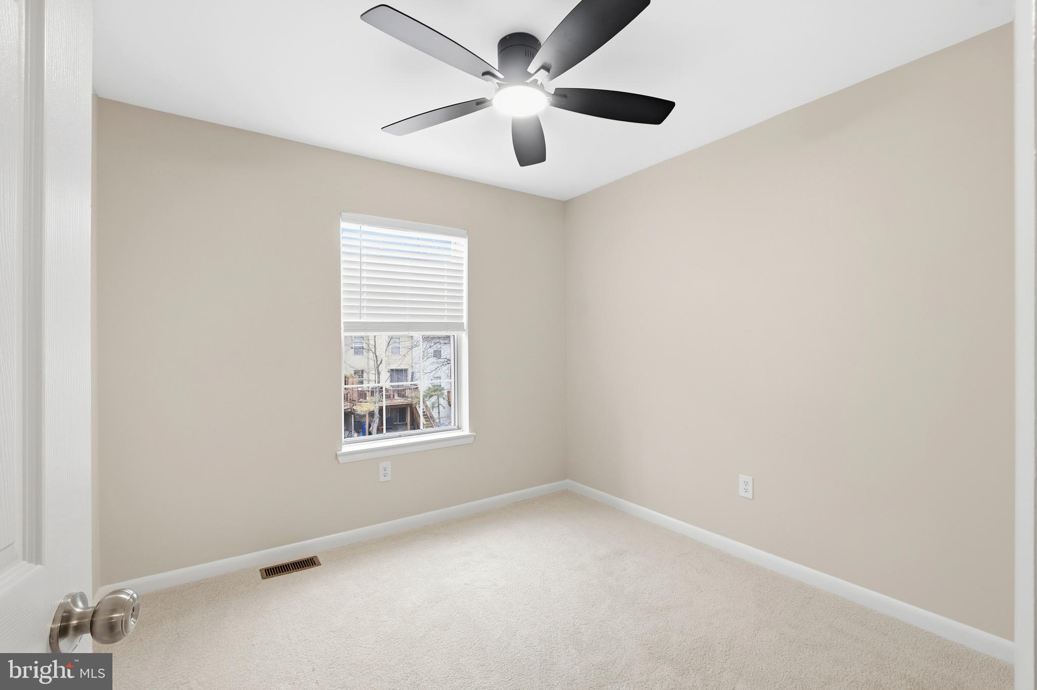 15012 Wheatland Place Laurel, MD 20707 - Photo 15 of 24 an empty room with a window and a ceiling fan