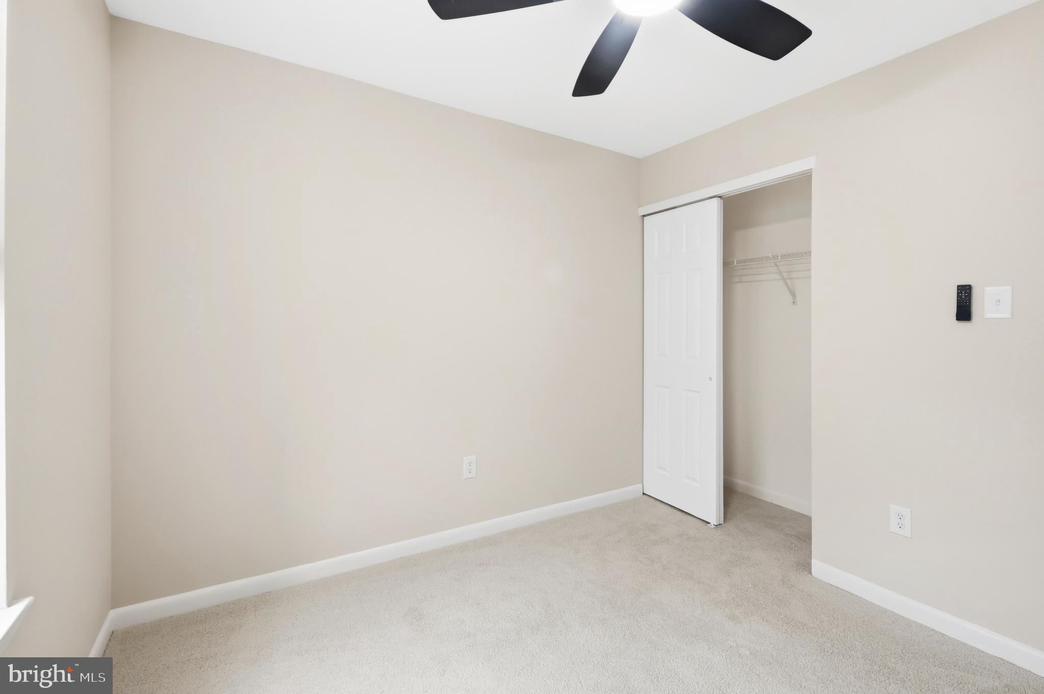 15012 Wheatland Place Laurel, MD 20707 - Photo 16 of 24 an empty room with a empty space and a ceiling fan