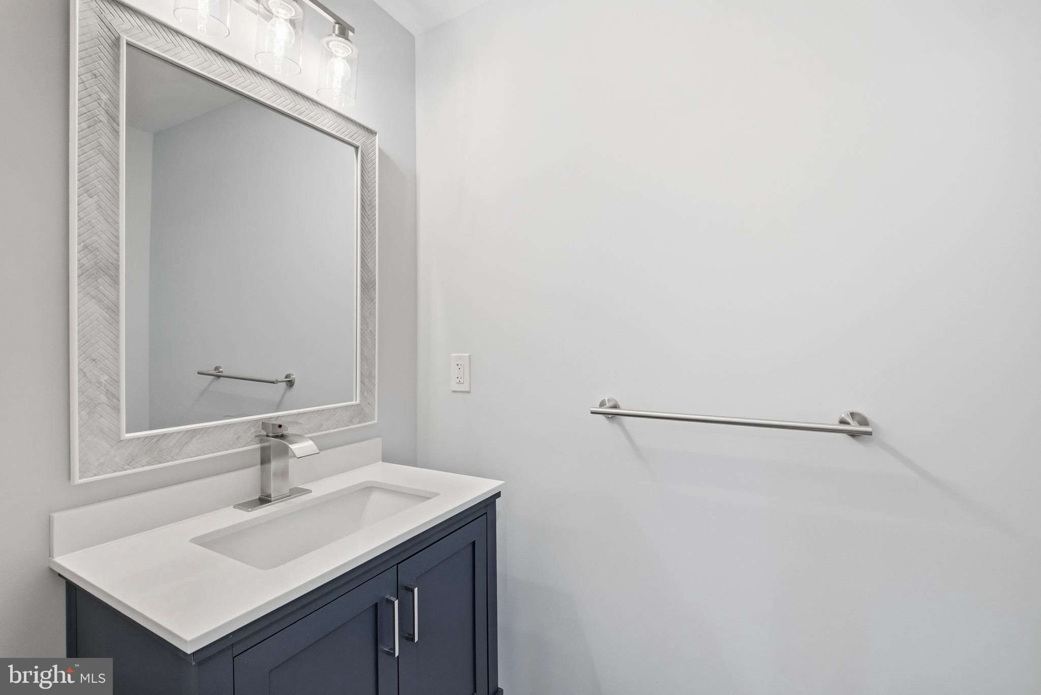 15012 Wheatland Place Laurel, MD 20707 - Photo 20 of 24 a bathroom with a sink and a mirror