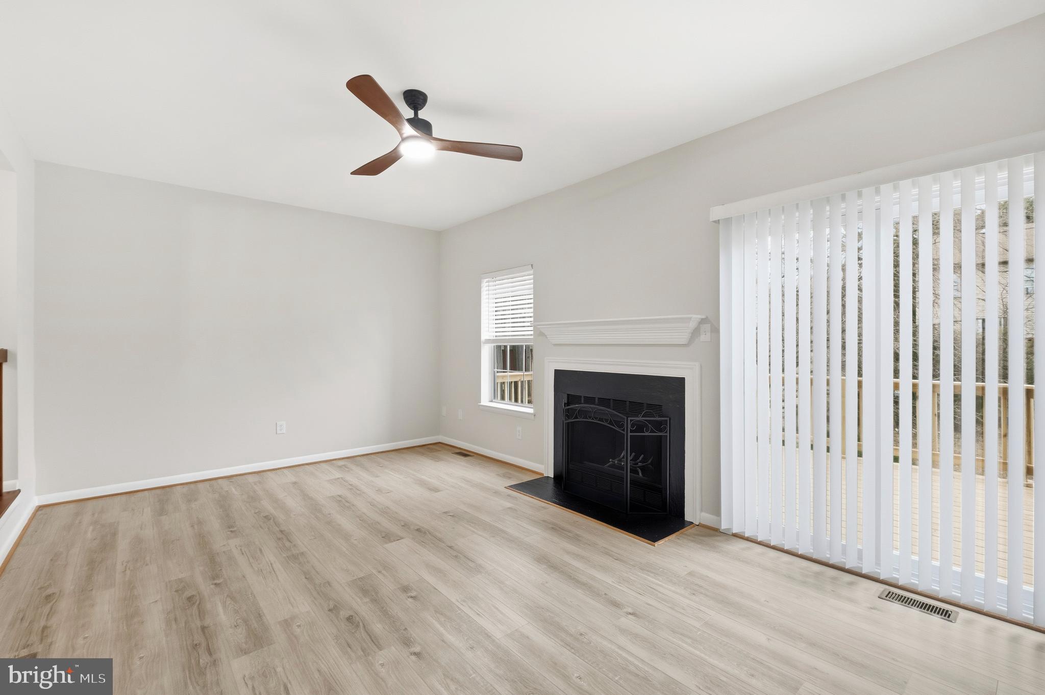 15012 Wheatland Place Laurel, MD 20707 - Photo 6 of 24 wooden floor in an empty room with a fireplace
