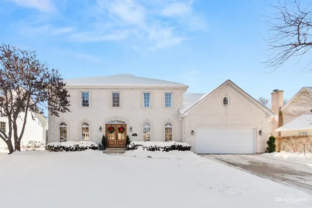 a view of a white house with a yard and garage