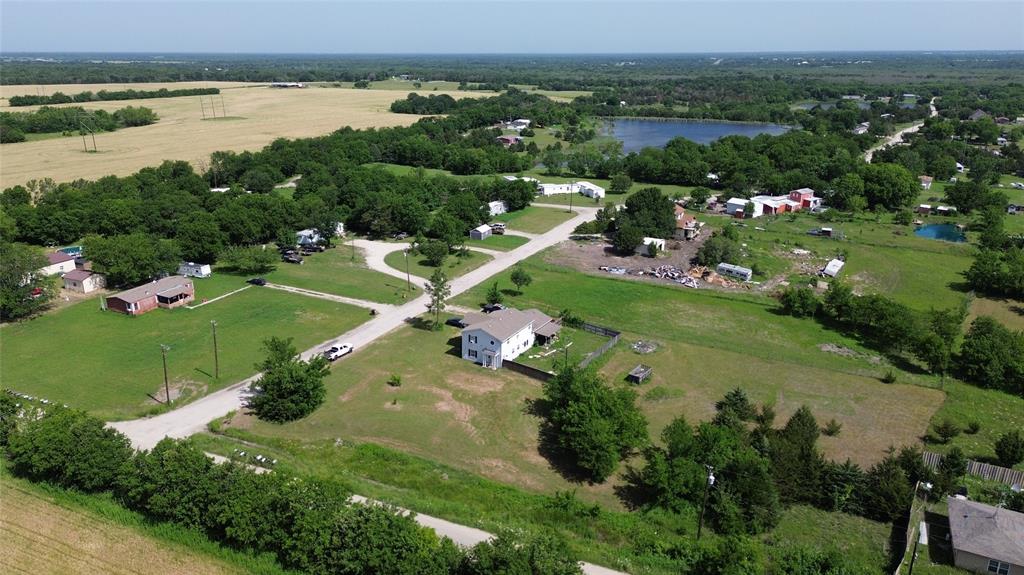 an aerial view of a houses with outdoor space and lake view