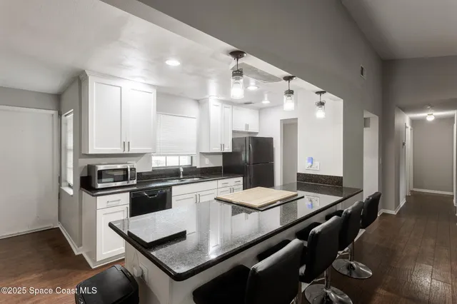 a kitchen with granite countertop stainless steel appliances lots of counter top space and stainless steel appliances