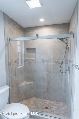 a bathroom with a shower and a toilet