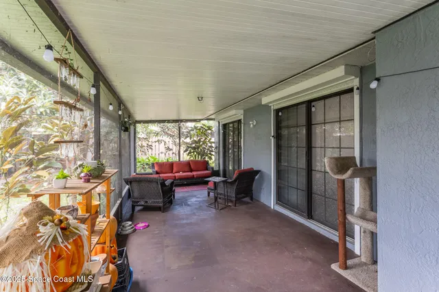 a living room with furniture a window and chairs