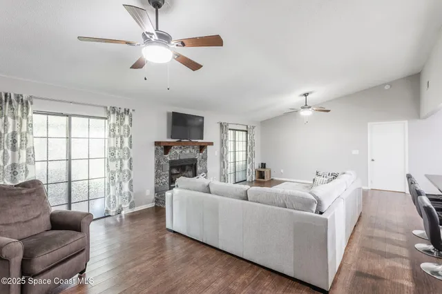 a living room with furniture fireplace and a window