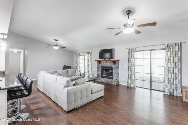 a living room with furniture a fireplace and a flat screen tv