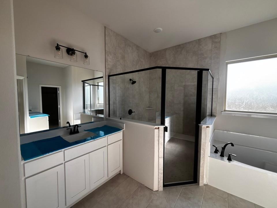 125 Pheasant Run Drive Rhome, TX 76078 - Photo 8 of 11 Dual vanity with white cabinetry, framed mirror, and contemporary light fixture