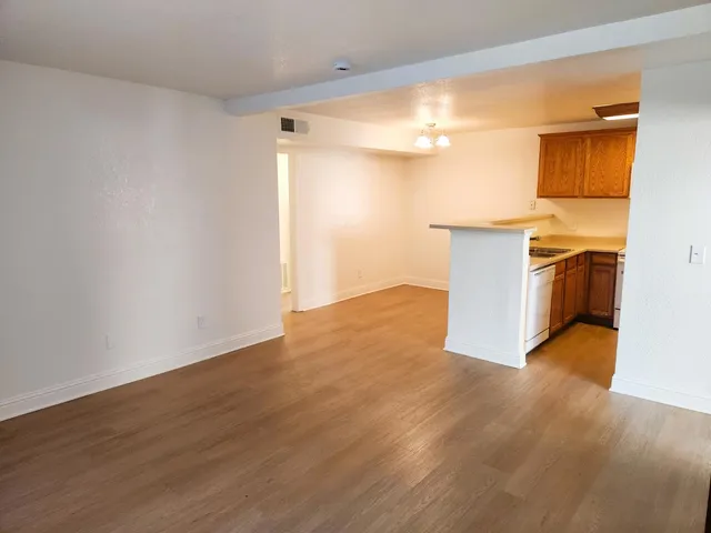 a view of a kitchen with wooden floor and a sink