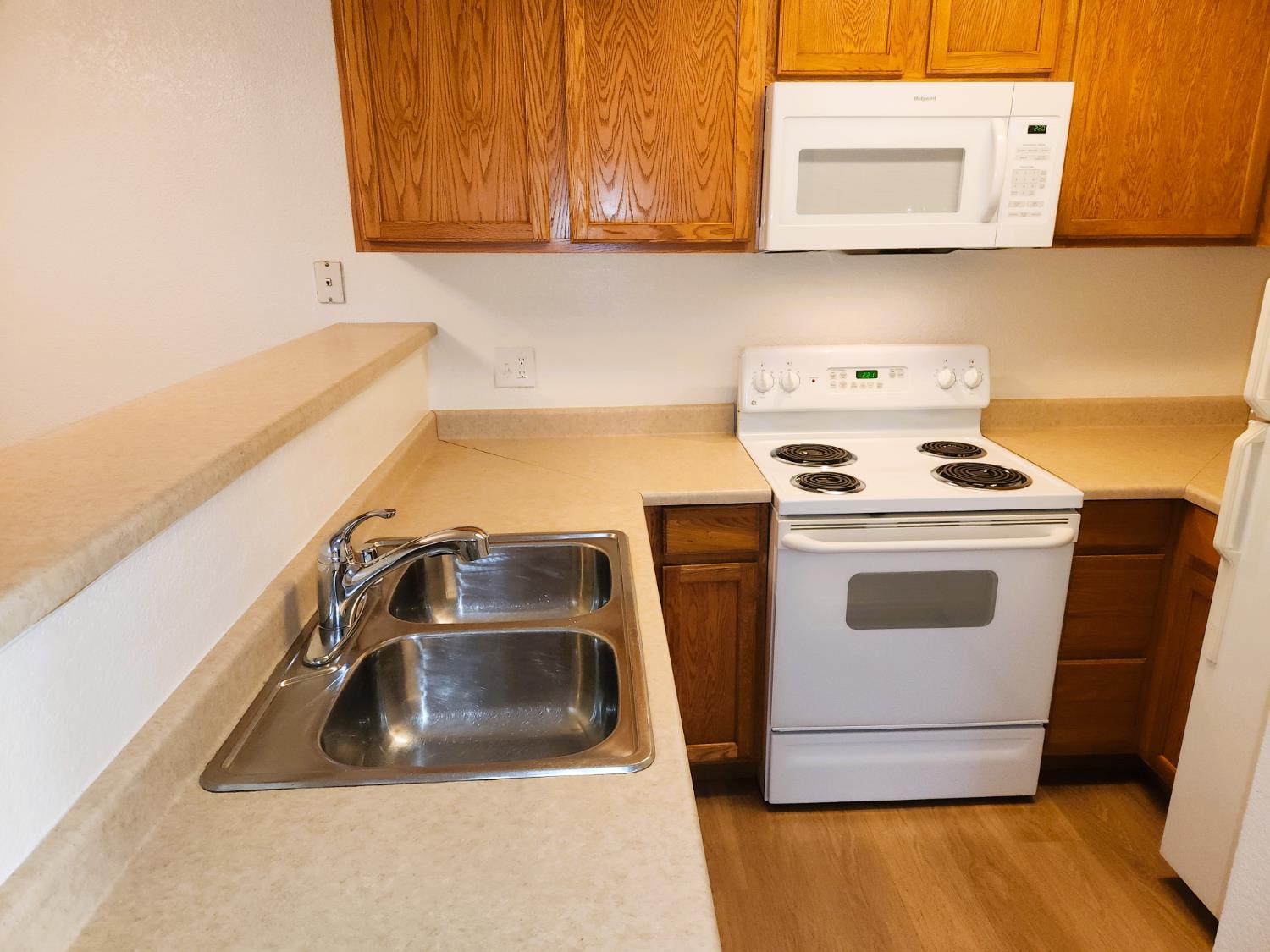 2909 Huntington Boulevard, Unit 105 Fresno, CA 93721 - Photo 4 of 7 a kitchen with a sink and a stove top oven