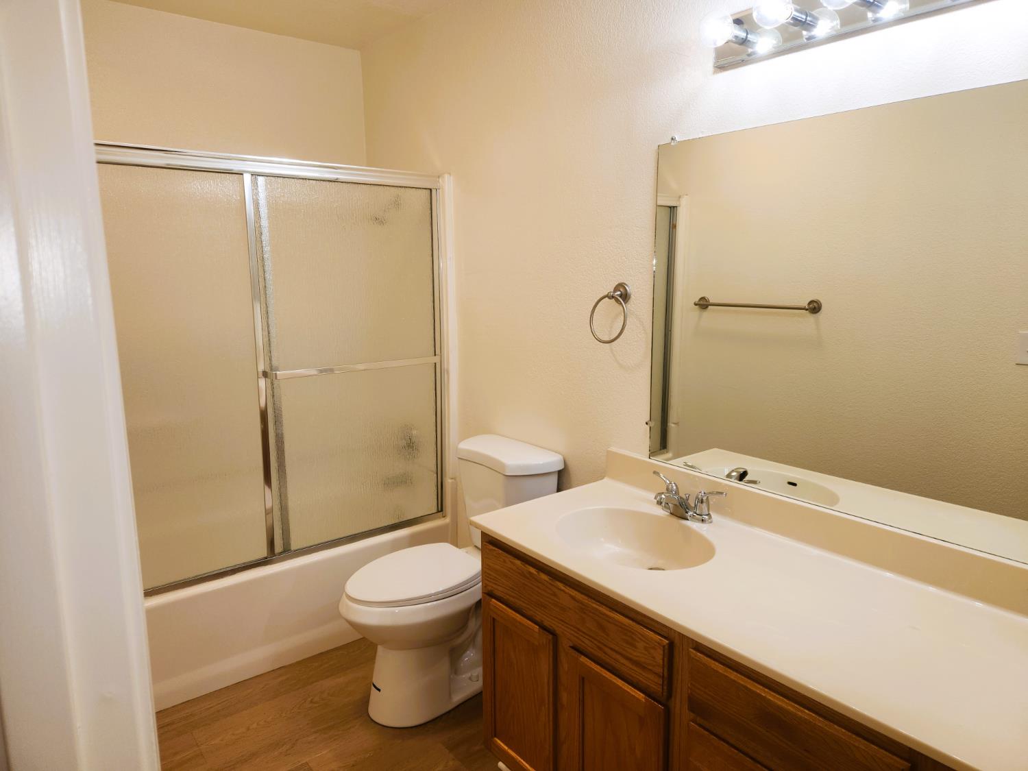 2909 Huntington Boulevard, Unit 105 Fresno, CA 93721 - Photo 6 of 7 a bathroom with a sink toilet and shower