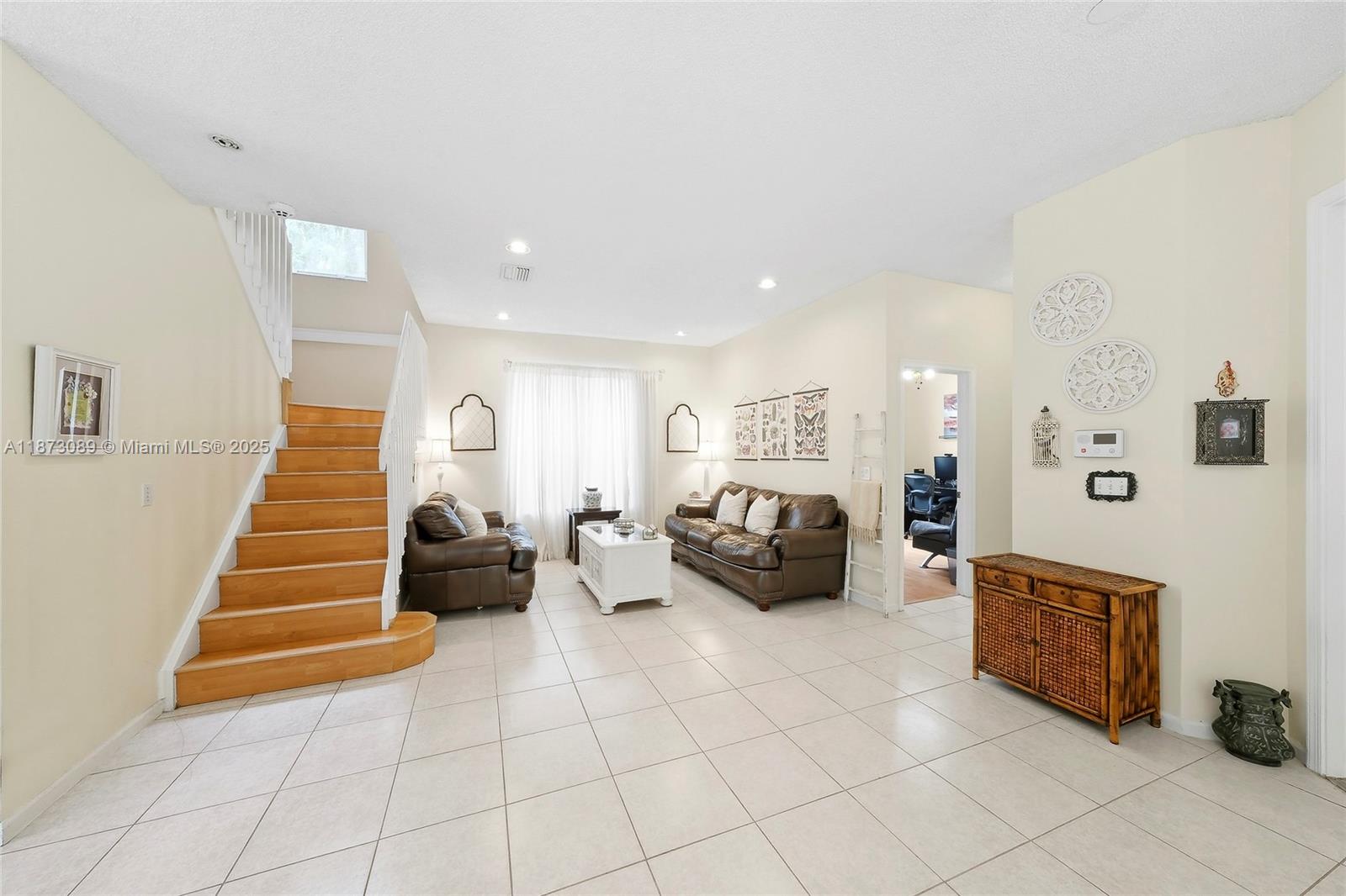 15025 Southwest 19th Court Miramar, FL 33027 - Photo 12 of 28 a living room with furniture and stairs